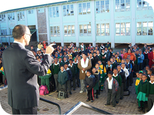 Dr Gary Paul addresses staff and learners during assembly at Greenville Primary School.